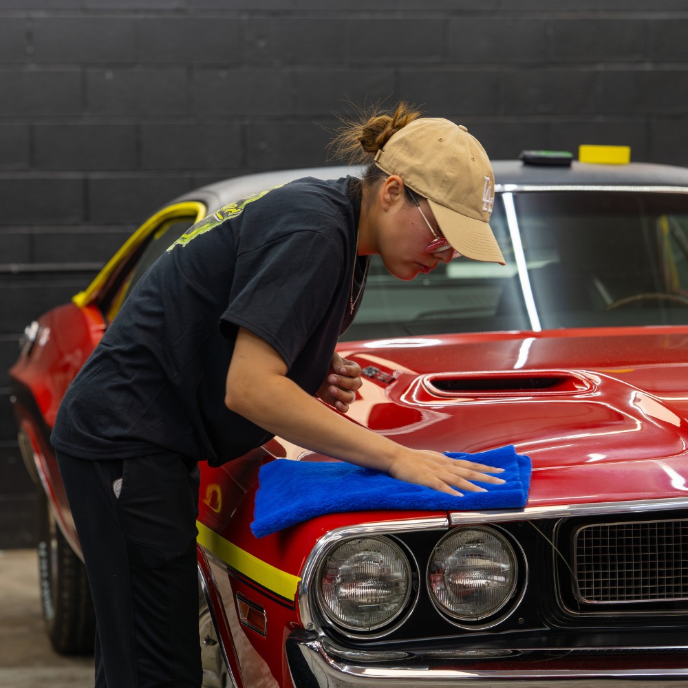 Classic muscle car being hand polished