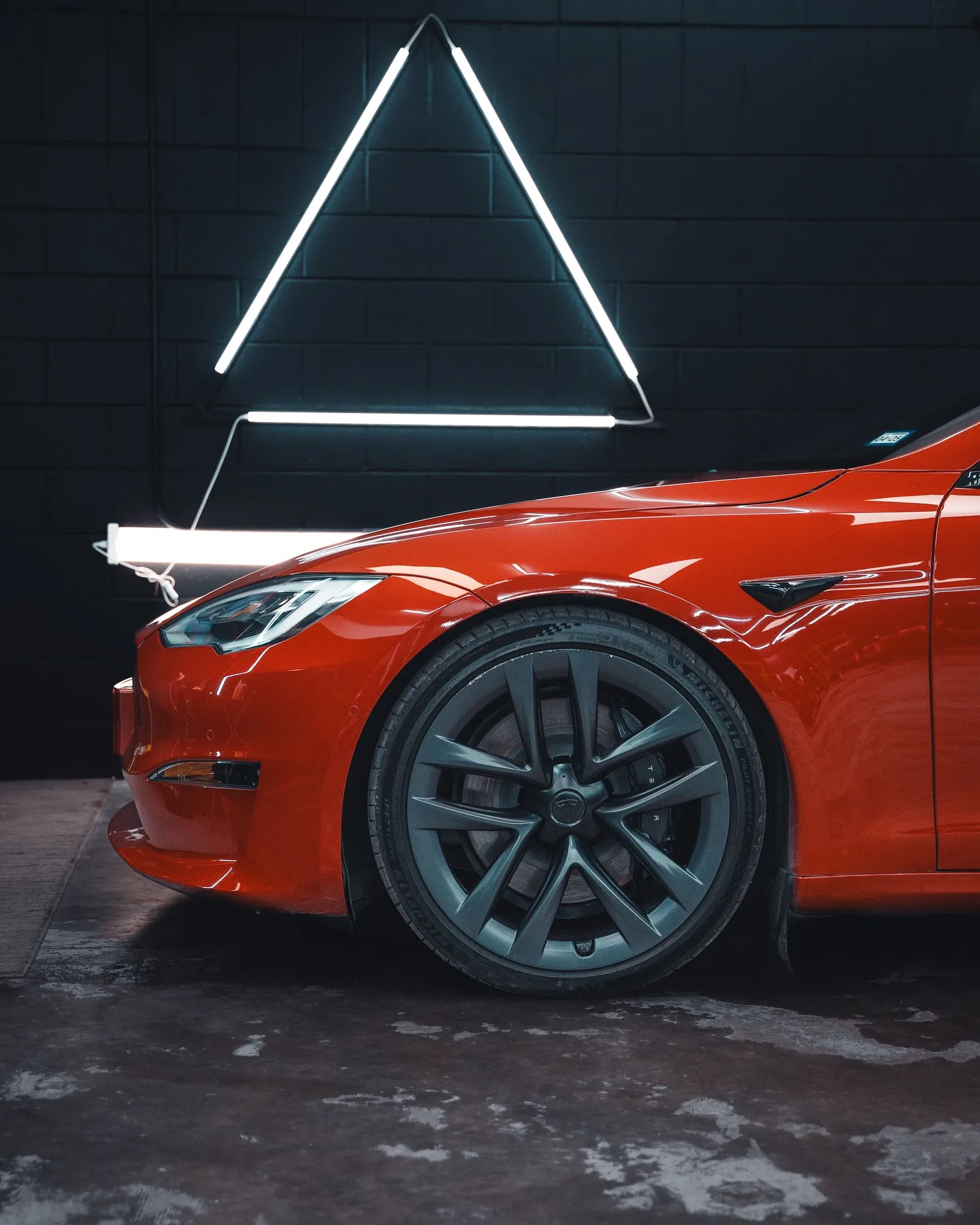 Red Tesla with ceramic coating showing mirror finish